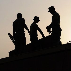 3 construction workers on roof