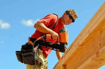 Construction Worker Using Nail Gun