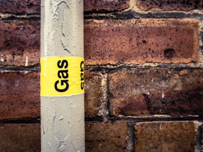 Gas Pipe In Front Of Brick Wall