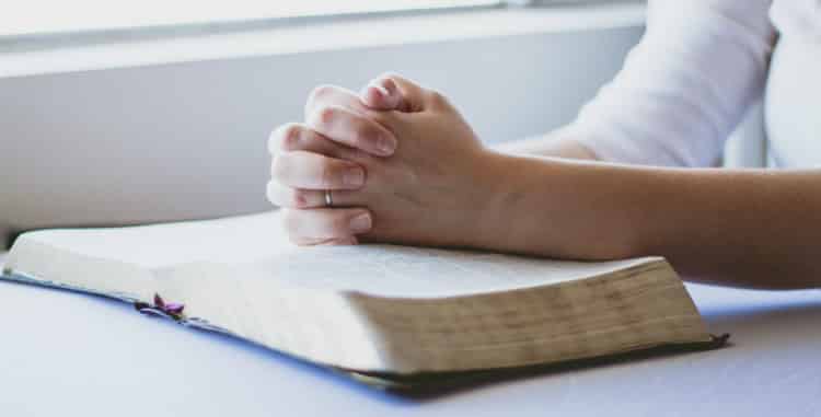 Woman Praying Over Bible