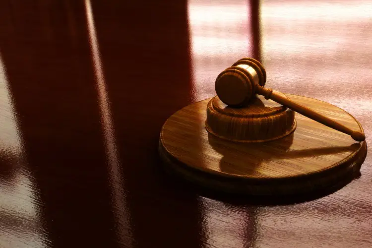 Wooden Gavel On Hotel Pool Drowning Lawyer's Desk