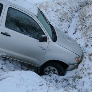 car in ditch after sideswipe accident